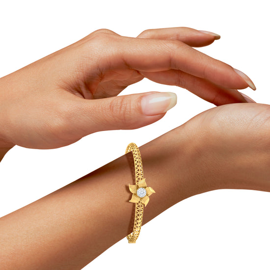 A Girl Wearing Floral Arrest Artificial Diamond  Gold Bracelet  Best Synthetic Diamond Jewelry in Chennai